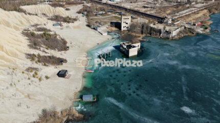 Frozen Rummu Quarry Lagoon and Submerged Ruins in Estonia Aerial View