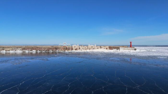Tallinn Paljassaare Aerial – Frozen Baltic Sea and Red Lighthouse in Winter, Estonia