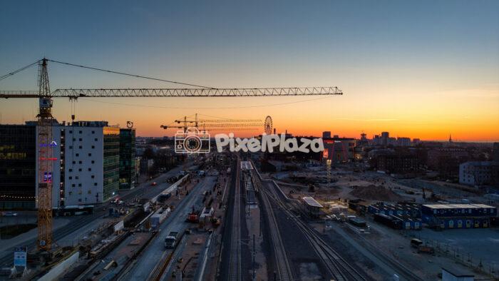 Drone perspective of urban construction and railway tracks in Tallinn at sunset