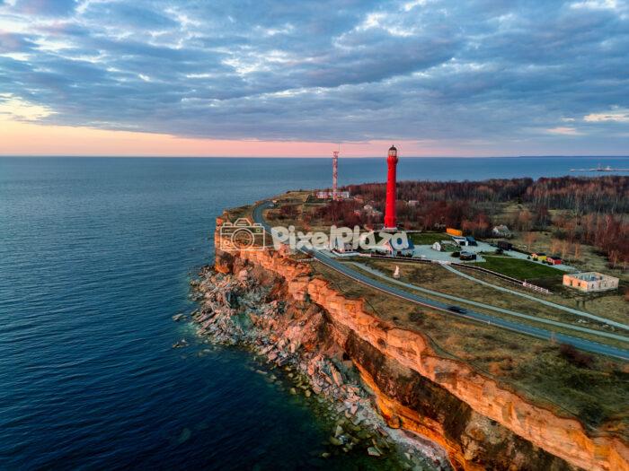 Pakri Lighthouse on Scenic Coastal Limestone Cliffs at Sunset in Estonia Pakri Lighthouse on Scenic Coastal Limestone Cliffs at Sunset in Estonia