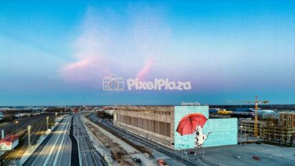 Sunset drone view of Ülemiste City mural and railway in Tallinn Estonia