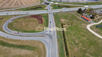 Aerial Highway Interchange and Curved Exit Ramp Traffic Drone View
