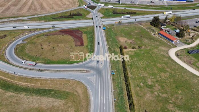 Aerial Highway Interchange and Curved Exit Ramp Traffic Drone View