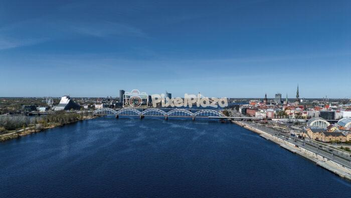Aerial Riga Cityscape featuring Daugava River and Railway Bridge in Latvia