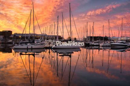 Dramatic sunset over sailboats at Admiralty Basin marina in Tallinn Estonia