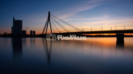 Vanšu Bridge silhouette at sunset over Daugava River in Riga Latvia