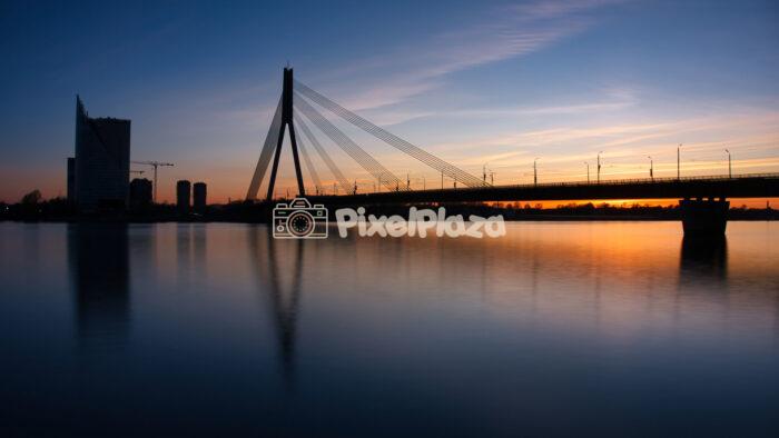 Vanšu Bridge silhouette at sunset over Daugava River in Riga Latvia Vanšu Bridge silhouette at sunset over Daugava River in Riga Latvia