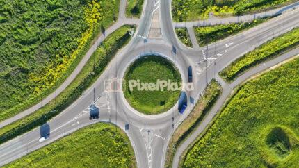 Aerial Drone Footage of Traffic Roundabout and Green Landscape in Summer 4K