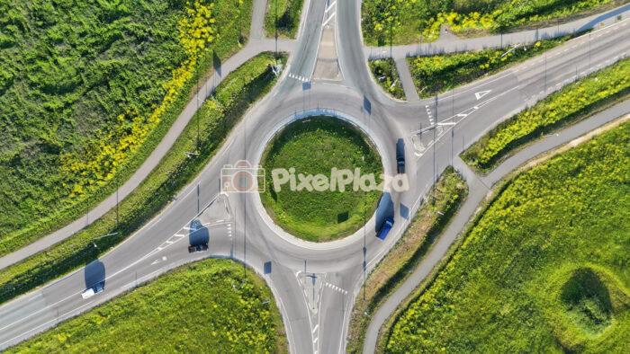 Aerial Drone Footage of Traffic Roundabout and Green Landscape in Summer 4K