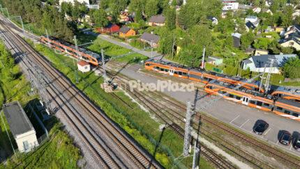 Drone 4K Video of Modern Orange Passenger Trains at Railway Junction in Estonia
