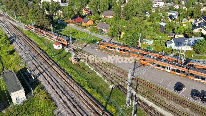 Drone 4K Video of Modern Orange Passenger Trains at Railway Junction in Estonia