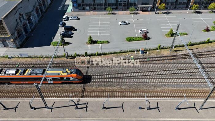 Aerial View of Electric Passenger Train on Tracks at Baltic Station