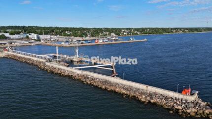Aerial view of marine industrial port breakwater and coastline landscape