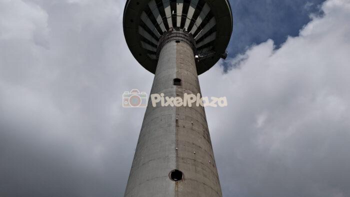 Low angle aerial view of iconic Tallinn TV Tower against dramatic sky in Estonia