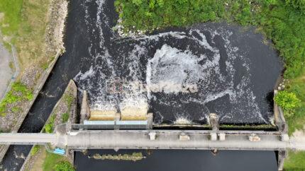 Top Down Aerial View of Water Dam with Foamy River Current in Estonia