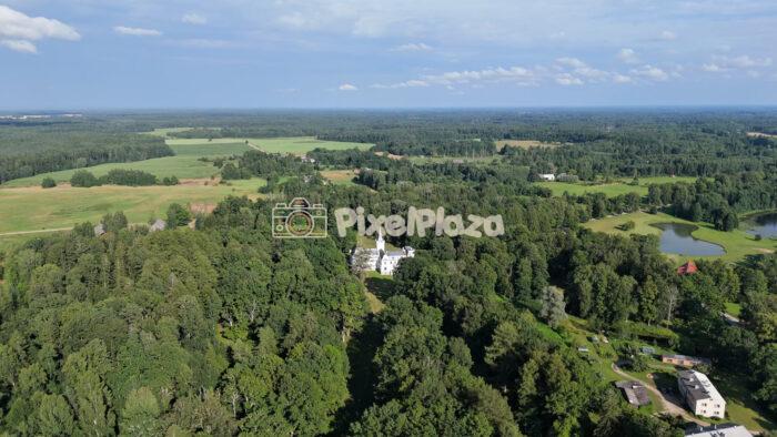 Aerial Drone Panning Shot over White Castle in Forest