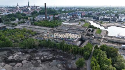 Aerial Pan Over Brutalist Concrete Building and City Skyline