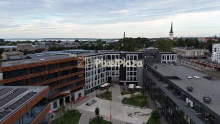 Aerial shot panning over modern urban business district and courtyard