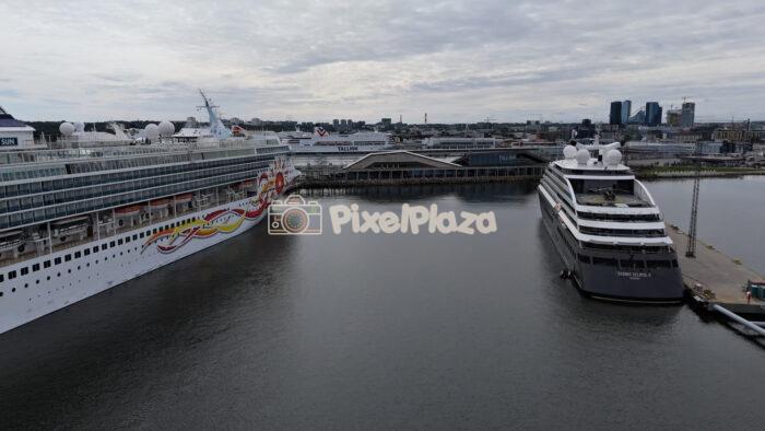 Drone shot flying over luxury cruise ships docked at harbor