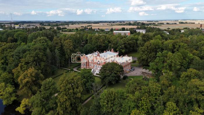 Aerial Flyover of Historic Red Brick Castle Hidden in Forest
